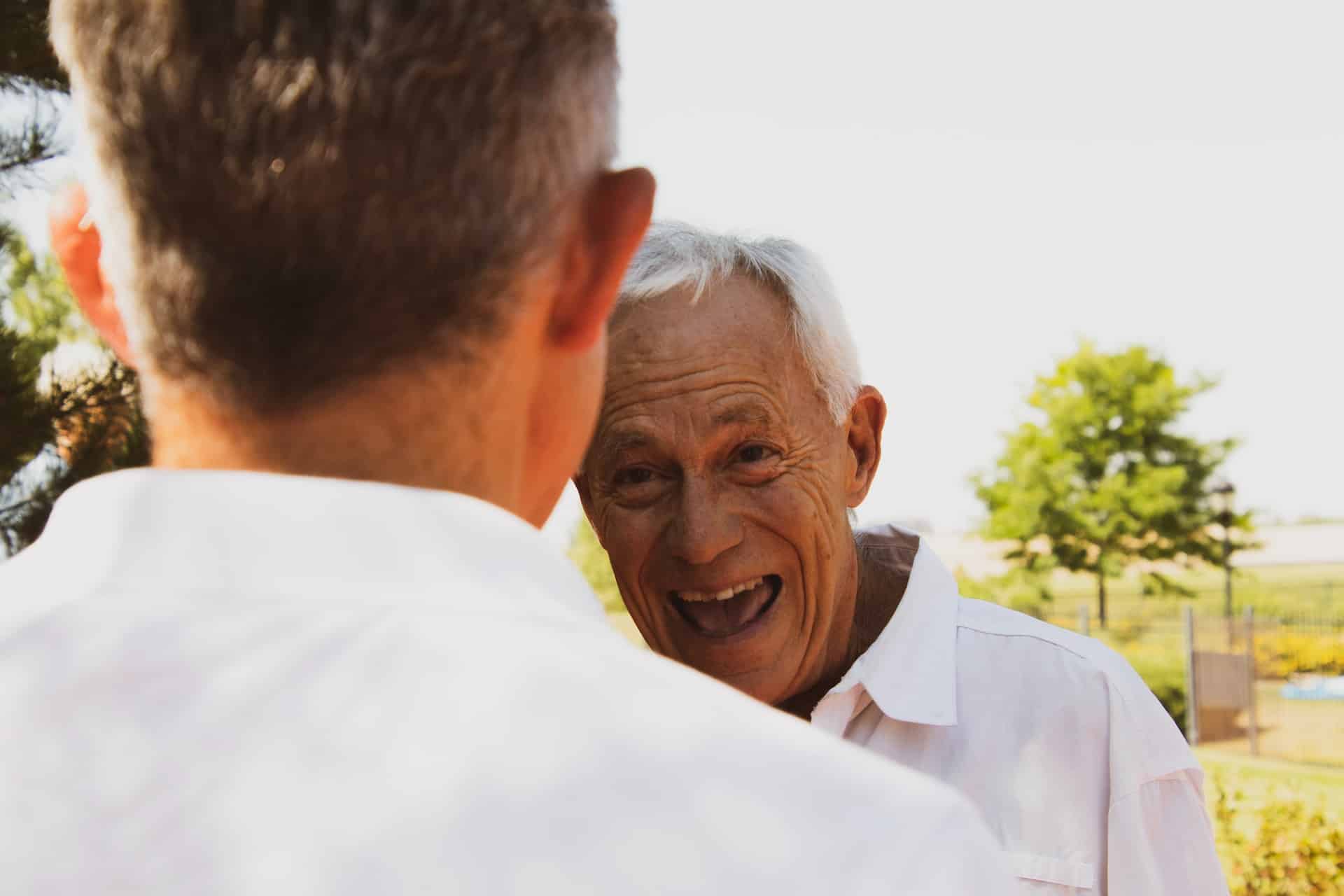 Happy man in front of a man in a white shirt